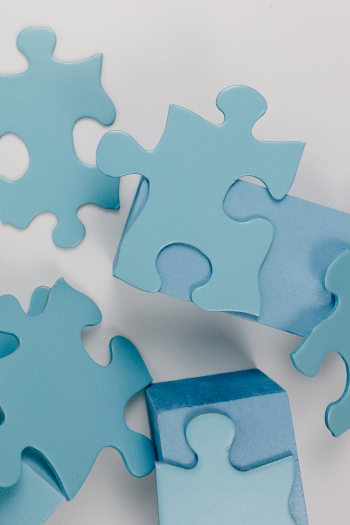 Detailed close-up of blue puzzle pieces randomly arranged on a white background.